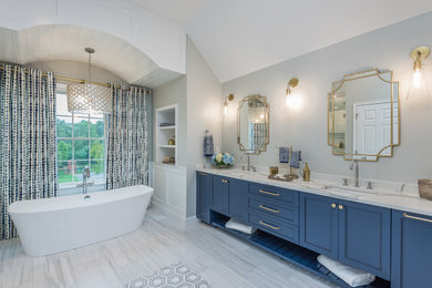 Large minimalist master gray tile and ceramic tile ceramic tile, gray floor and double-sink bathroom photo in Boston with recessed-panel cabinets, blue cabinets, a one-piece toilet, gray walls, an undermount sink, quartz countertops, a hinged shower door, white countertops and a built-in vanity