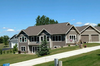 Inspiration for a mid-sized timeless brown two-story mixed siding gable roof remodel in Minneapolis