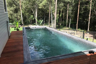 Mid-sized modern backyard rectangular aboveground pool in Gold Coast - Tweed with decking.