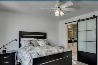 Example of a minimalist master light wood floor bedroom design in Nashville with white walls