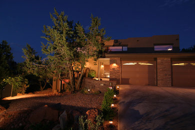 Large southwestern brown one-story stone exterior home idea in Phoenix