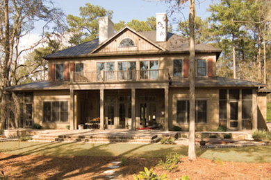 Large brown two-story wood exterior home photo in Austin