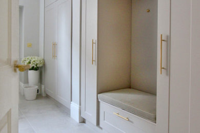 This is an example of a large contemporary cloakroom in Cheshire with shaker cabinets, grey cabinets, white walls and grey floors.