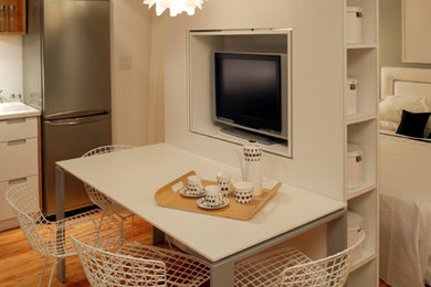 Example of a mid-sized trendy medium tone wood floor and brown floor kitchen/dining room combo design in Philadelphia with beige walls and no fireplace