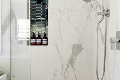 Bathroom - large transitional master porcelain tile porcelain tile, gray floor and double-sink bathroom idea in Minneapolis with shaker cabinets, beige cabinets, a two-piece toilet, an undermount sink, solid surface countertops, a hinged shower door, a niche and a built-in vanity