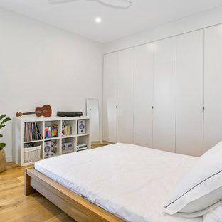 Inspiration for a contemporary guest bedroom in Sydney with white walls, light hardwood floors and beige floor.