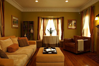 Living room - mid-sized traditional formal and enclosed dark wood floor and brown floor living room idea in Los Angeles with a standard fireplace, a wood fireplace surround and green walls