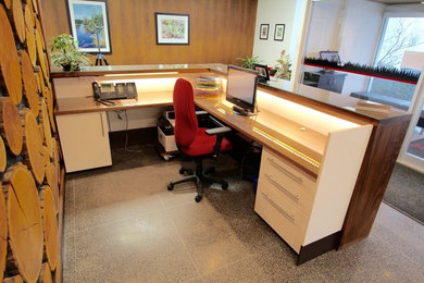 Inspiration for a contemporary built-in desk concrete floor study room remodel in Toronto with white walls