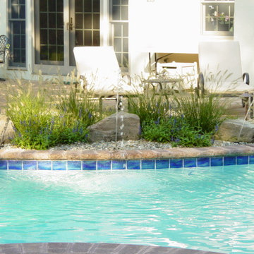 Water shoots from pools along edge of pool