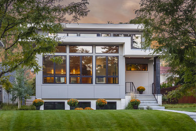 Large trendy gray two-story mixed siding flat roof photo in Minneapolis