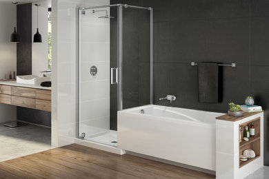 This is an example of a contemporary bathroom in Montreal with an alcove tub, a corner shower, gray tile, black walls and light hardwood floors.