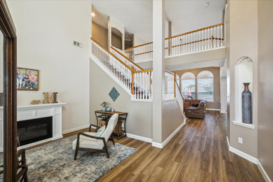 Mid-sized trendy vinyl floor and beige floor foyer photo in Houston with brown walls