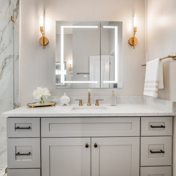 Modern Gray Vanity with Backlit Mirror and Marble Shower