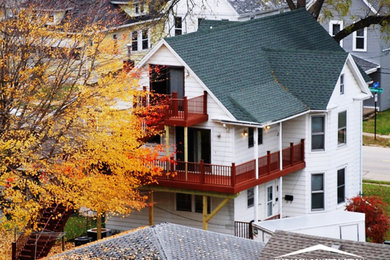 Inspiration for a timeless white three-story duplex exterior remodel in Cedar Rapids