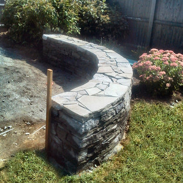 Curved fieldstone wall in progress