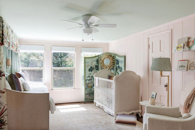 Inspiration for a large timeless girl wall paneling nursery remodel in Houston with pink walls