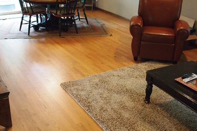 Mid-sized elegant medium tone wood floor living room photo in Other