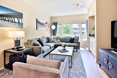 Inspiration for a small contemporary enclosed light wood floor living room remodel in Seattle with beige walls and a tv stand