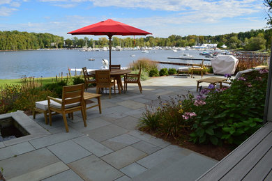 Patio - mid-sized modern backyard stone patio idea in Burlington with no cover