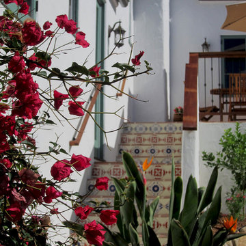 A Santa Barbara Spanish Revival outdoor staircase with decorative tiles.