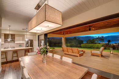 Inspiration for a large coastal dark wood floor and brown floor kitchen/dining room combo remodel in Hawaii with white walls and no fireplace