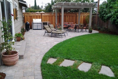 Mid-sized trendy backyard brick patio kitchen photo in San Francisco with a pergola