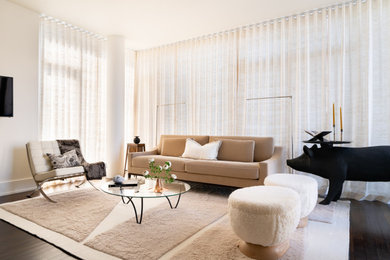 Large minimalist dark wood floor and brown floor living room photo in New York with beige walls