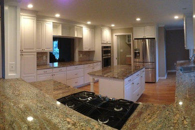Traditional kitchen in Baltimore with raised-panel cabinets, white cabinets and granite benchtops.