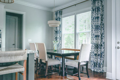 Example of a large transitional medium tone wood floor and brown floor breakfast nook design in Raleigh with gray walls and a standard fireplace