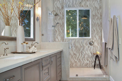 Inspiration for a mid-sized transitional master beige tile and porcelain tile porcelain tile and beige floor bathroom remodel in Orange County with recessed-panel cabinets, distressed cabinets, a two-piece toilet, beige walls, an undermount sink and quartzite countertops