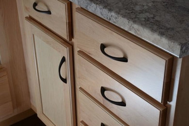 Inspiration for a coastal medium tone wood floor kitchen remodel in Toronto with a double-bowl sink, recessed-panel cabinets, light wood cabinets, laminate countertops, white appliances and a peninsula