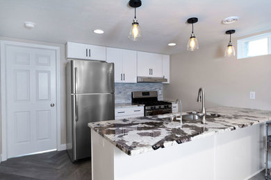 Example of a vinyl floor and gray floor kitchen design in Other