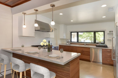 Minimalist u-shaped eat-in kitchen photo with a drop-in sink, flat-panel cabinets, marble countertops, white backsplash, subway tile backsplash, stainless steel appliances, a peninsula and white countertops