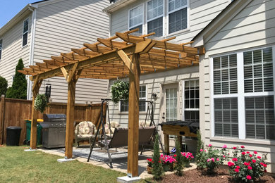 Patio - mid-sized traditional backyard concrete patio idea in Atlanta with an awning