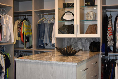 Walk-in closet - mid-sized contemporary women's walk-in closet idea in Miami with shaker cabinets and medium tone wood cabinets