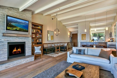 Mid-sized elegant formal and open concept medium tone wood floor and beige floor living room photo in Other with beige walls, a standard fireplace, a tile fireplace and a wall-mounted tv