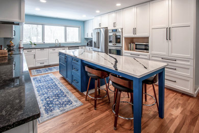 Inspiration for a mid-sized transitional u-shaped eat-in kitchen remodel in Cleveland with flat-panel cabinets and white cabinets