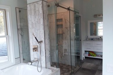 Inspiration for a mid-sized modern master gray tile and marble tile gray floor bathroom remodel in Other with flat-panel cabinets, white cabinets, blue walls, an undermount sink, marble countertops and gray countertops