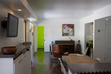 Living room - mid-sized 1950s enclosed and formal dark wood floor and brown floor living room idea in Atlanta with white walls, a wall-mounted tv, a standard fireplace and a brick fireplace
