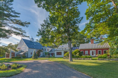Large farmhouse gray three-story mixed siding exterior home photo in Portland Maine with a metal roof