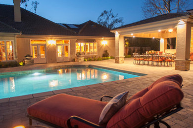 Patio - large traditional backyard concrete paver patio idea in San Diego with a fire pit and a gazebo
