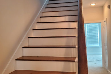 Staircase - painted straight mixed material railing staircase idea in Houston with wooden risers