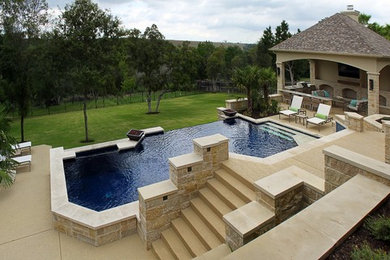 Pool - large modern backyard rectangular infinity pool idea in Austin