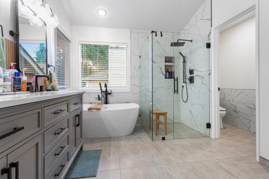 Inspiration for a mid-sized contemporary master black and white tile and porcelain tile porcelain tile, gray floor and double-sink bathroom remodel in Seattle with shaker cabinets, gray cabinets, a bidet, white walls, an undermount sink, quartz countertops, a hinged shower door, white countertops, a niche and a freestanding vanity