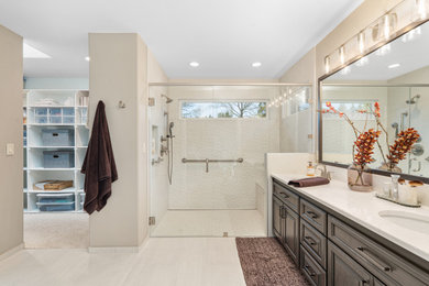 Example of a mid-sized transitional master white tile and ceramic tile porcelain tile, white floor and double-sink bathroom design in Portland with brown cabinets, an undermount sink, quartz countertops, a hinged shower door, white countertops and a built-in vanity