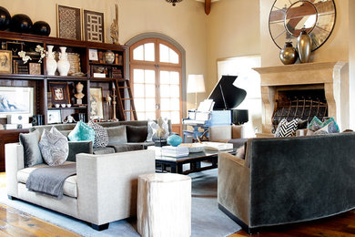 Example of a large eclectic open concept medium tone wood floor living room design in Philadelphia with a music area, beige walls, a standard fireplace and a stone fireplace