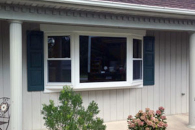 Mid-sized white one-story wood exterior home photo in Other
