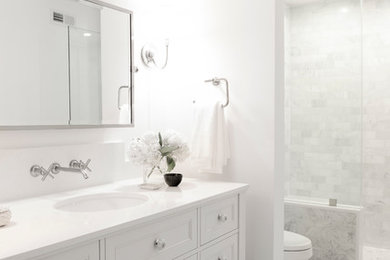 Photo of a small transitional 3/4 bathroom in Los Angeles with shaker cabinets, white cabinets, a two-piece toilet, white tile, ceramic tile, white walls, mosaic tile floors, an undermount sink and solid surface benchtops.