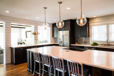 Inspiration for a country l-shaped separate kitchen in Nashville with an undermount sink, shaker cabinets, dark wood cabinets, quartzite benchtops, grey splashback, subway tile splashback, stainless steel appliances, dark hardwood floors and with island.