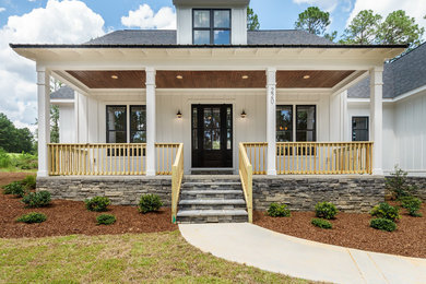 Photo of a country home design in Raleigh.